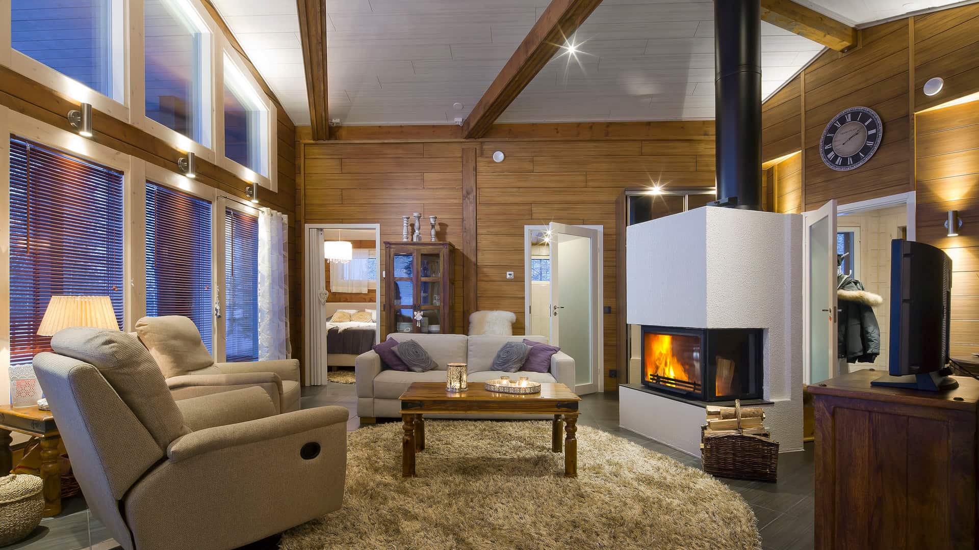 Spacious lounging area of Holiday home Nuuna. The fireplace at the middle gives a cosy feeling during cold winter days.