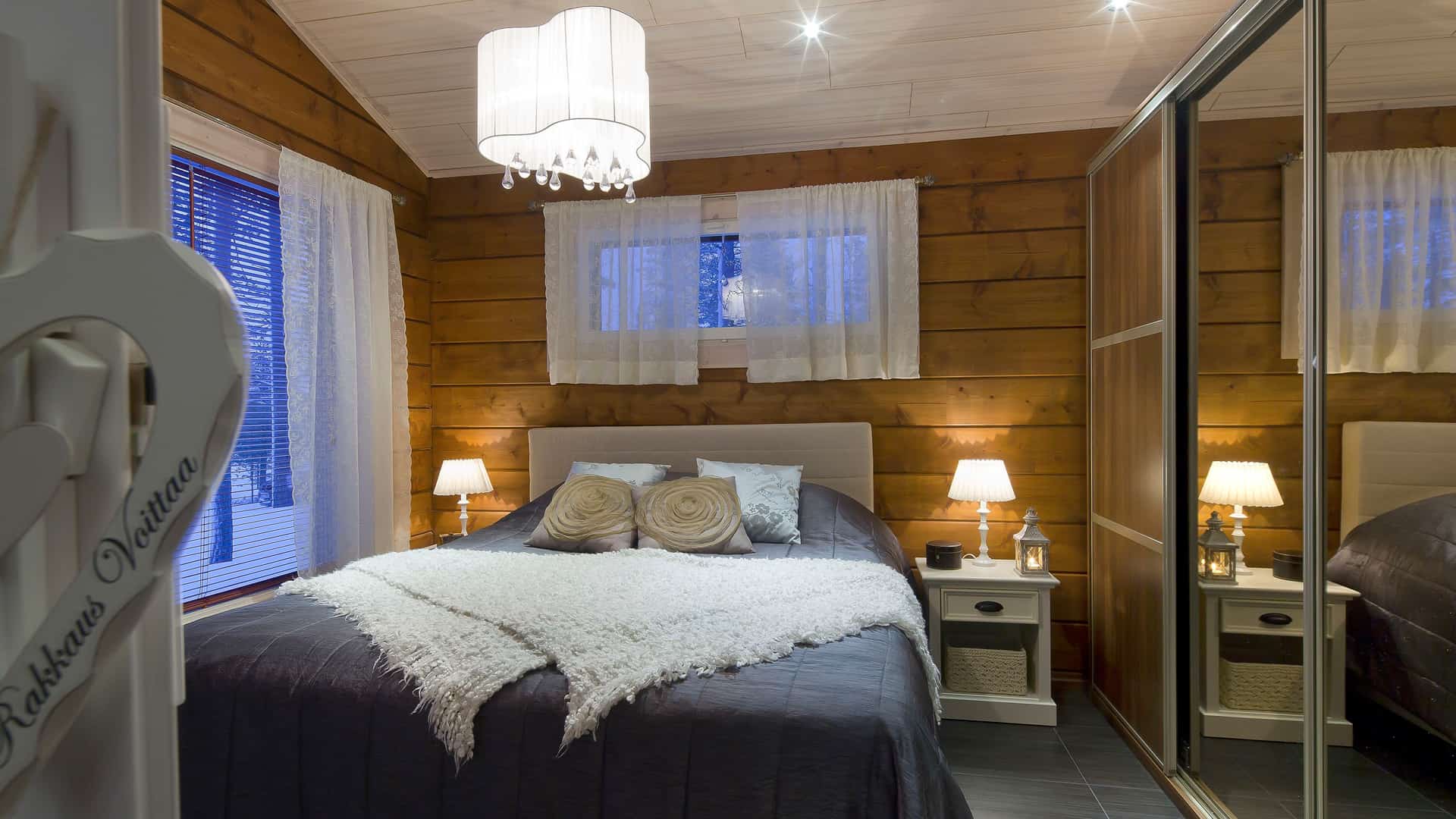 The master bedroom of Holiday Home Nuuna. The brown log walls give a cozy feeling. 