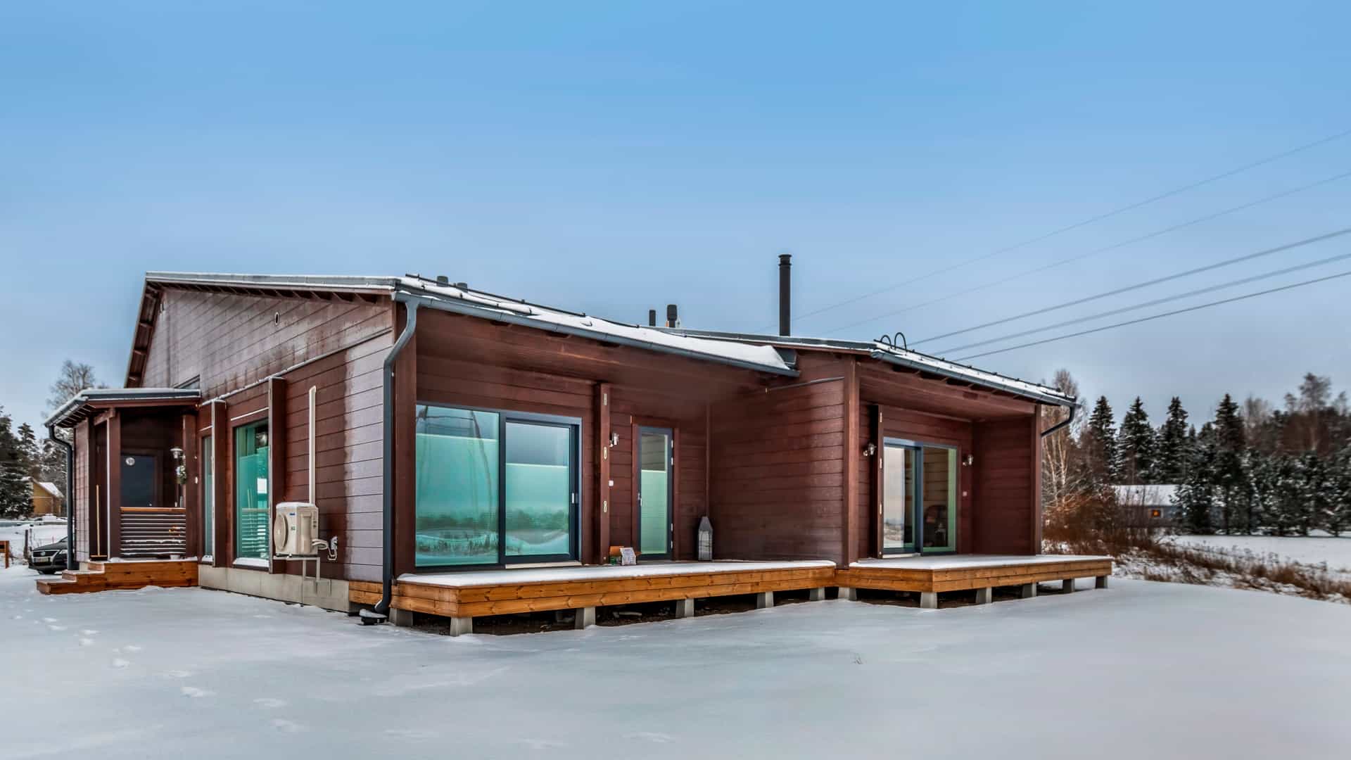 Outdoor photo of the log semi-detached home.