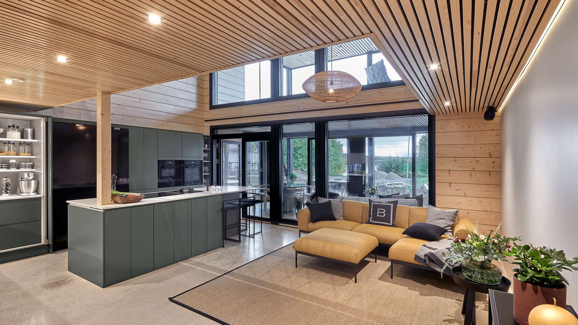 The kitchen and living room are in the same space. The kitchen has a beautiful batten ceiling with embedded led lights.