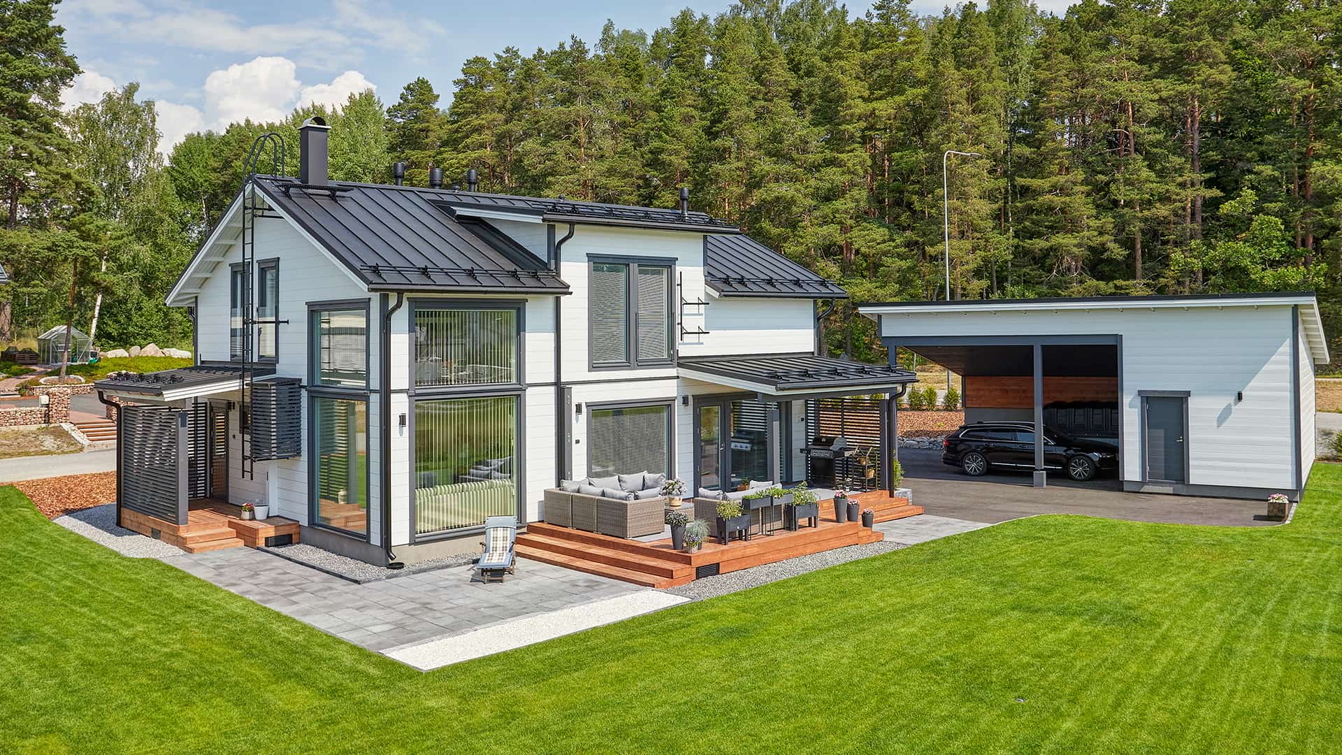 Experiences of living in a log home: the back yard There is terrace on the back yard with room for a barbecue grill and a sofa set. The large lawn is already turning green.