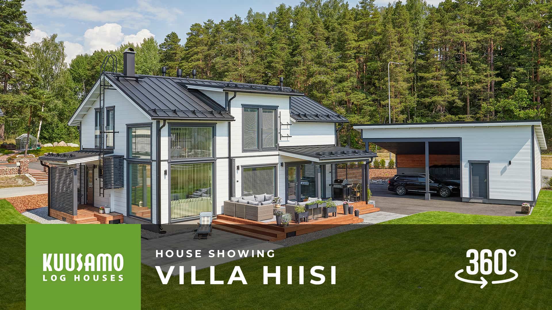 We welcome you to take a tour of the Villa Hiisi log home! The white two-storey Villa Hiisi log house has a grey gabled roof. The windows and doors are also grey. The backyard lawn is starting to grow.